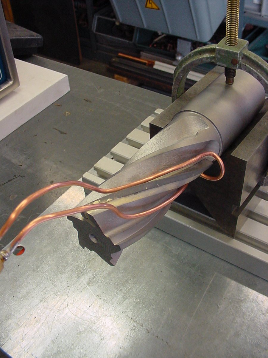 Custom induction coil for soldering a metal cutting tool