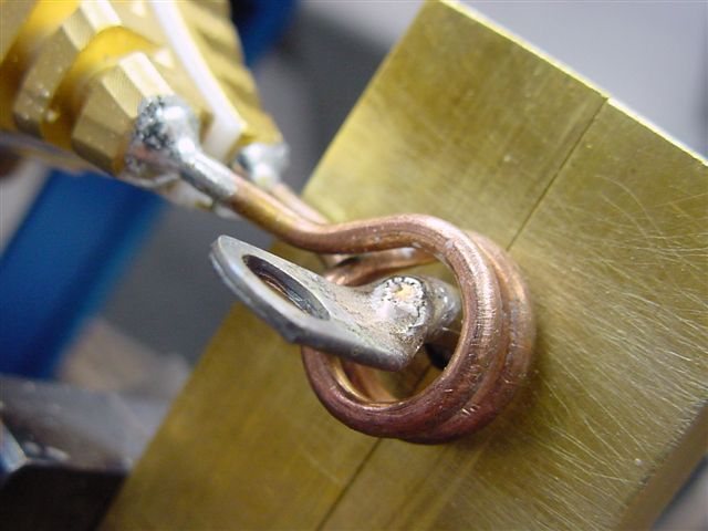 Induction soldering of an electrical component with a small induction coil